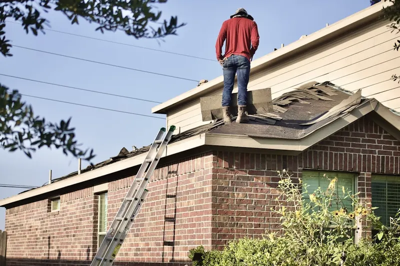 Professional roofer working on a residential roof in Lions Park